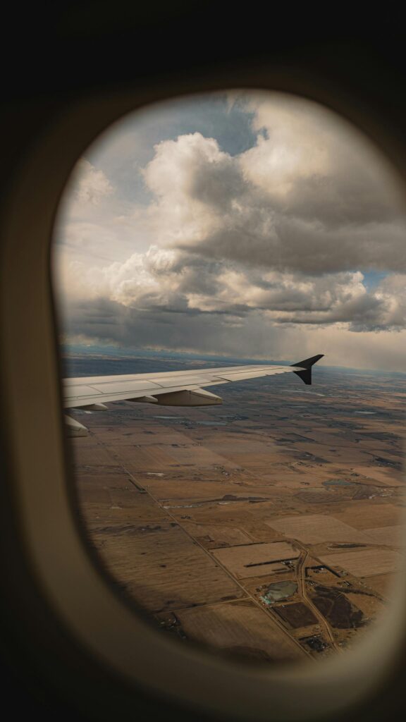 Stunning Aerial View from Airplane Window Cloudy Sky Mobile Wallpaper
