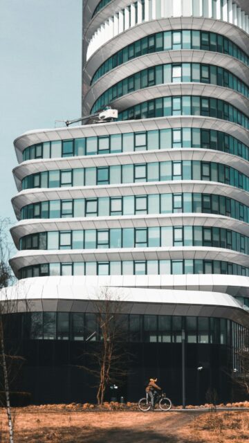 Modern Corporate Skyscraper with Cyclist Mobile Wallpaper