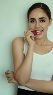 Beautiful Woman Eating a Fresh Strawberry Portrait Mobile Wallpaper