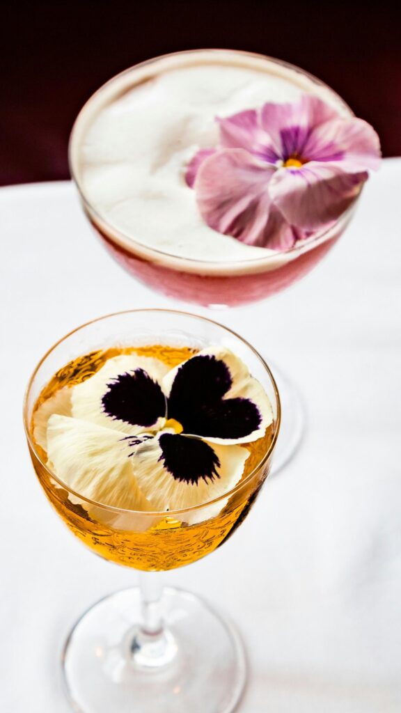 Elegant Cocktails with Pansy Flower Garnishes Mobile Wallpaper