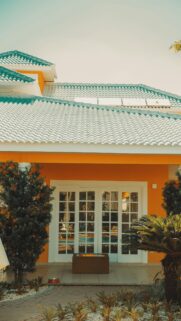 Sunny Orange Villa Exterior with Tiled Roof Mobile Wallpaper