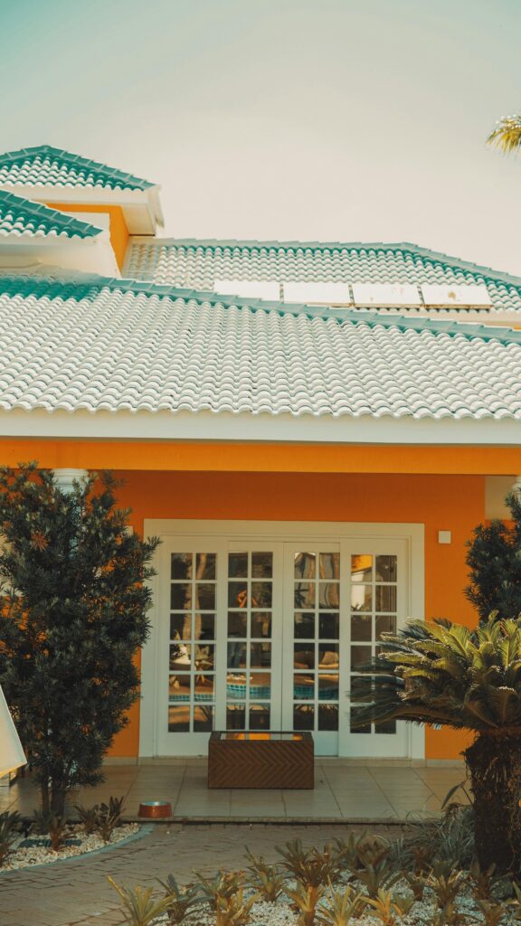 Sunny Orange Villa Exterior with Tiled Roof Mobile Wallpaper