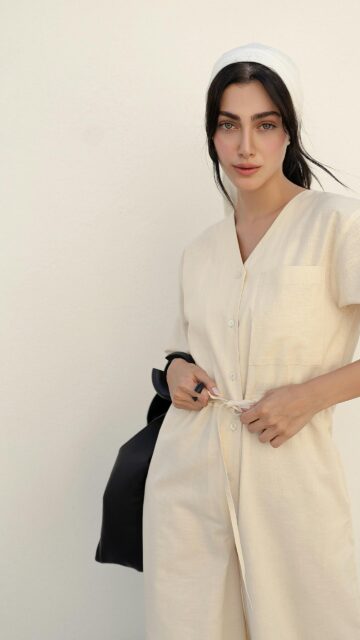 Elegant Woman in Cream Linen Jumpsuit and Headscarf Mobile Wallpaper