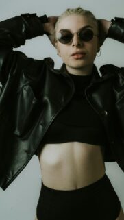 Edgy Blonde Woman in Leather Jacket and Sunglasses Cool Aesthetic Wallpaper