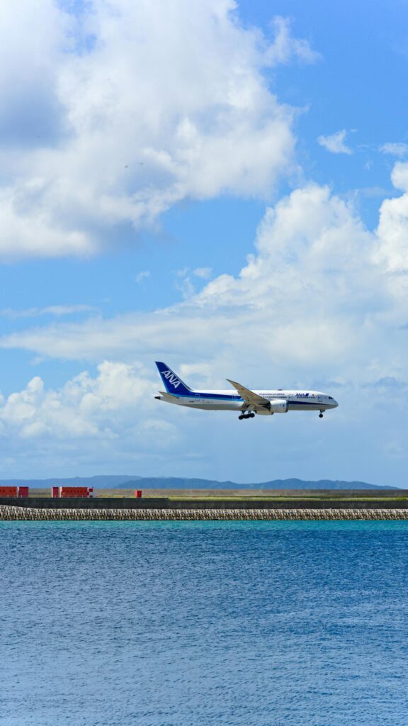 ANA Boeing 787 Dreamliner Landing over Tropical Blue Sea Wallpaper