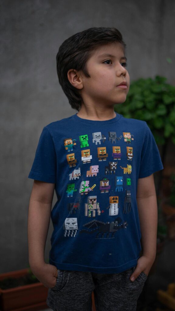 Cute Boy Wearing Minecraft T-Shirt Portrait Mobile Wallpaper