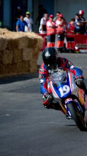 Professional Motorcycle Racer Speeding on Track Wallpaper