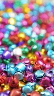 Vibrant Rainbow Colored Jingle Bells Festive Macro Wallpaper