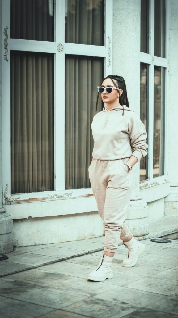 Stylish Woman in Beige Sportswear Aesthetic Phone Wallpaper