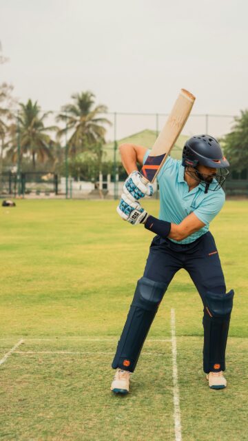 Professional Cricket Batsman in Action Sports Mobile Wallpaper
