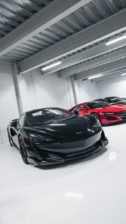 Black McLaren and Red Acura Supercars in Modern Garage Wallpaper