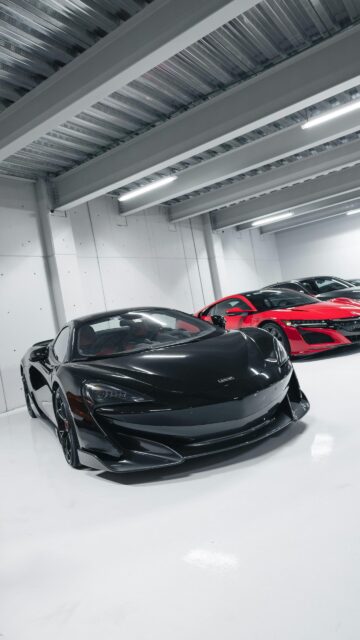 Black McLaren and Red Acura Supercars in Modern Garage Wallpaper