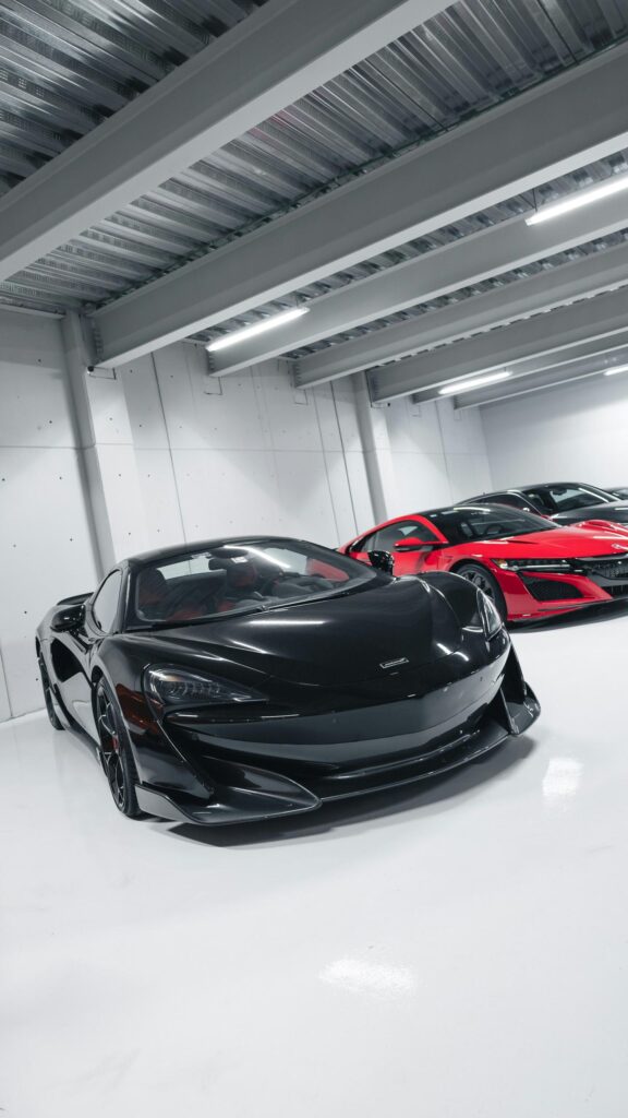 Black McLaren and Red Acura Supercars in Modern Garage Wallpaper