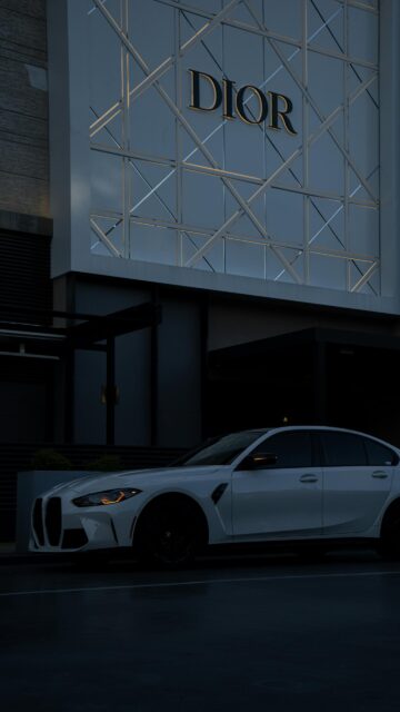 White BMW M3 Sedan Parked at Dior Luxury Boutique Wallpaper