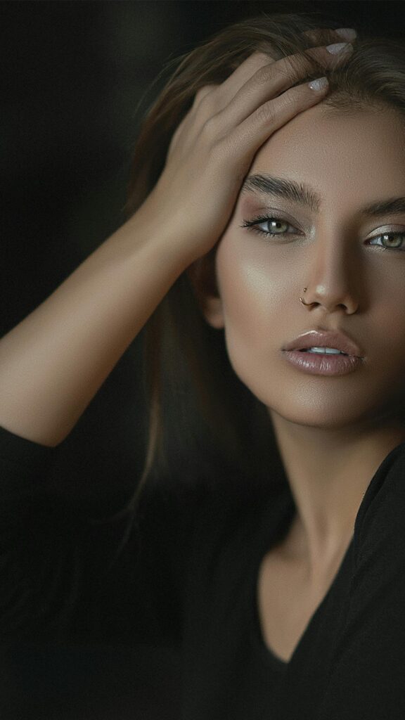 Beautiful Woman Portrait with Piercing and Dark Background Mobile Wallpaper