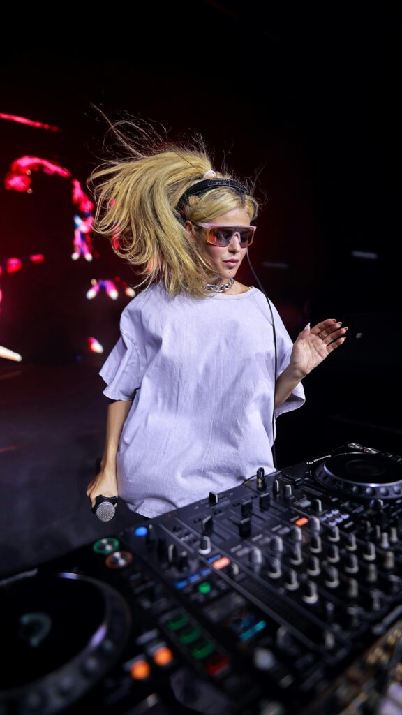 DJ Girl Performing with Blonde Ponytail Live Music Mobile Wallpaper