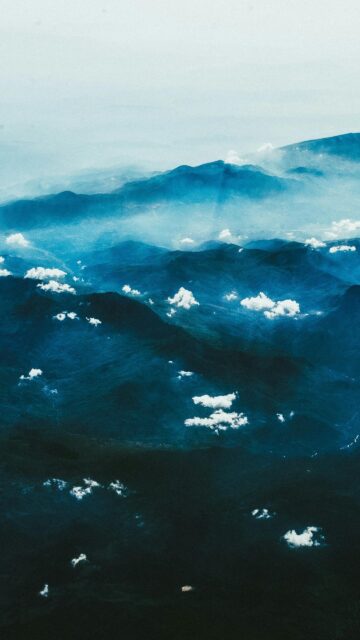 Stunning Aerial View of Misty Blue Mountains and Scattered Clouds Wallpaper