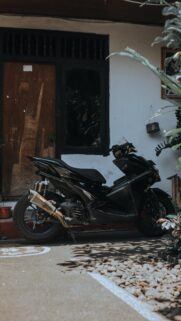 Sleek Black Yamaha Aerox Motorcycle Parking Outdoor Wallpaper