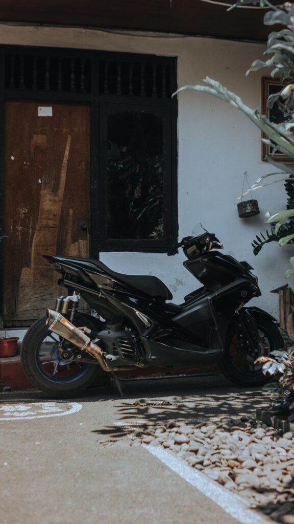 Sleek Black Yamaha Aerox Motorcycle Parking Outdoor Wallpaper