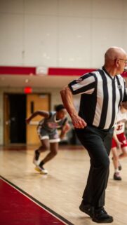 Basketball Referee and Player Action Shot Mobile Wallpaper