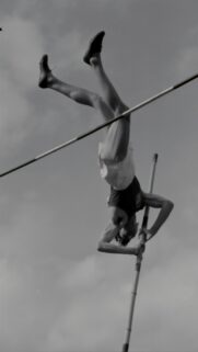 Vintage Pole Vault Athlete Mid-Air Action Shot Mobile Wallpaper