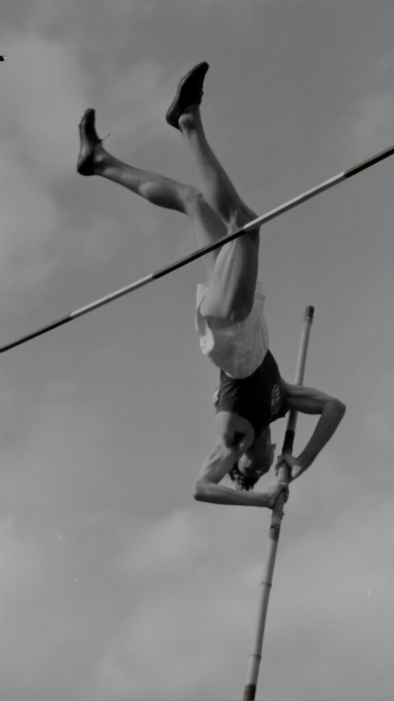 Vintage Pole Vault Athlete Mid-Air Action Shot Mobile Wallpaper