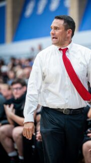 Focused Basketball Coach in White Shirt and Red Tie Mobile Wallpaper