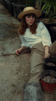 Aesthetic Country Girl in Straw Hat Greenhouse Portrait Wallpaper