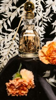 Elegant Jimmy Choo Perfume Bottle with Orange Flowers Luxury Wallpaper