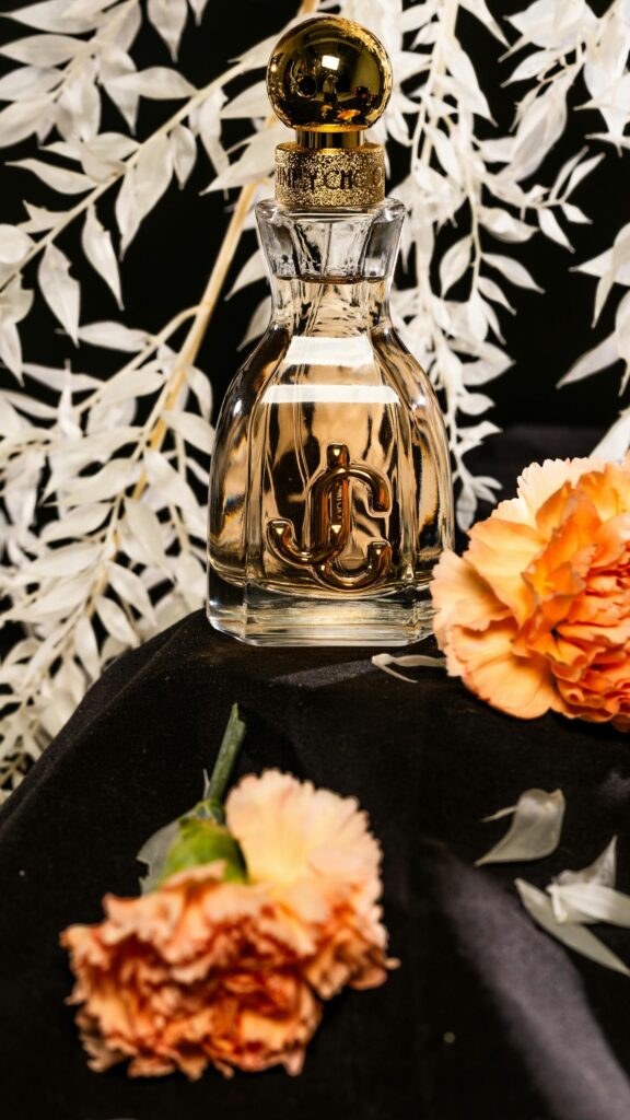 Elegant Jimmy Choo Perfume Bottle with Orange Flowers Luxury Wallpaper