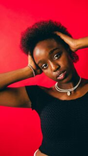 Stunning Portrait of a Radiant Young Woman with Natural Hair Wallpaper