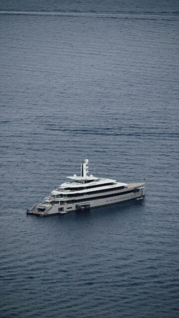 Stunning Luxury Superyacht Sailing on Deep Blue Sea Mobile Wallpaper