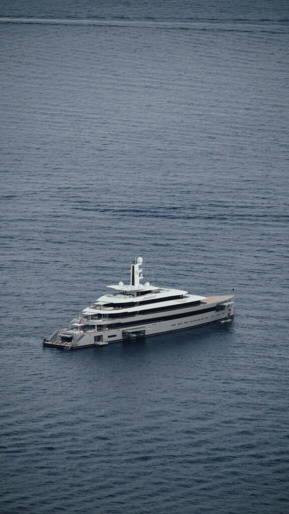 Stunning Luxury Superyacht Sailing on Deep Blue Sea Mobile Wallpaper