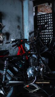 Gritty Custom Motorcycle Engine in Dim Workshop Mobile Wallpaper