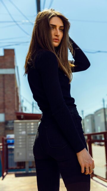 Stunning Brunette Woman in Casual Black Outfit Phone Wallpaper