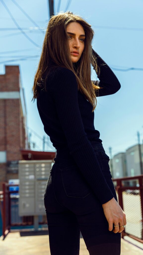 Stunning Brunette Woman in Casual Black Outfit Phone Wallpaper