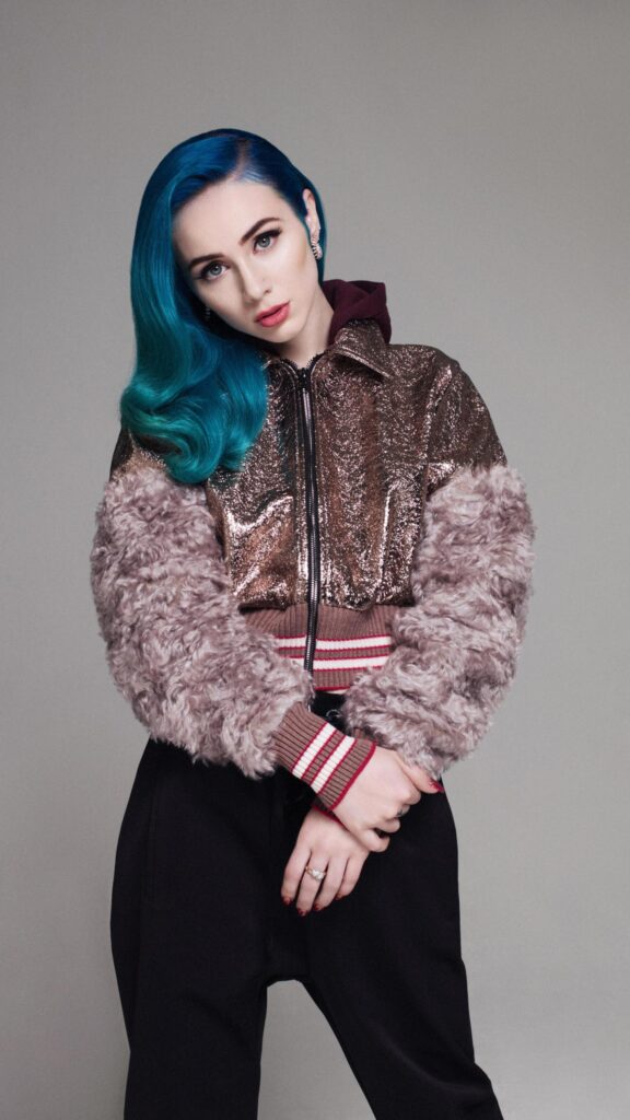 Fashion Model with Vibrant Blue Hair in Metallic Texture Jacket Wallpaper