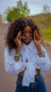Stylish African Woman in Sunglasses and White Shirt Portrait Wallpaper