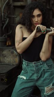Stunning Industrial Beauty Portrait with Curly Hair Mobile Wallpaper