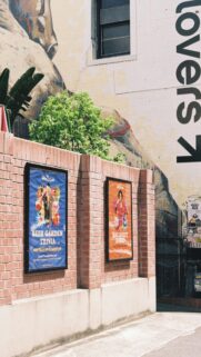 Urban Brick Wall and Event Posters Outdoor Scene 4K Mobile Wallpaper