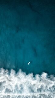 Stunning Aerial Surfer in Deep Blue Ocean Minimalist Mobile Wallpaper