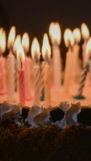 Festive Birthday Cake with Glowing Candles Mobile Wallpaper
