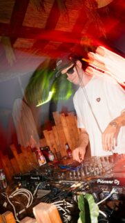 Dynamic DJ Performing at Night Party Mobile Wallpaper