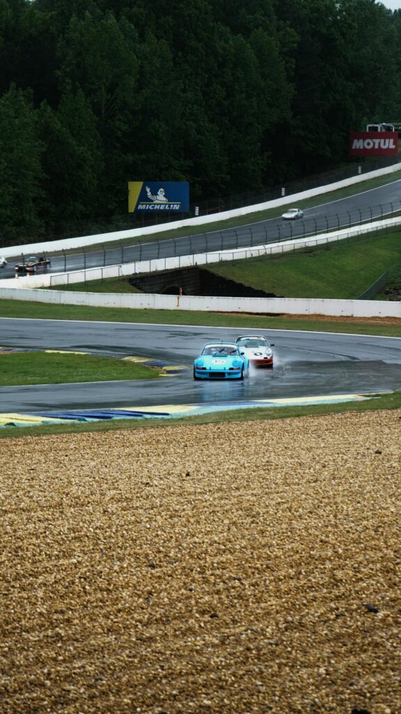 Blue Porsche 911 Racing in Rain at Road Atlanta Mobile Wallpaper