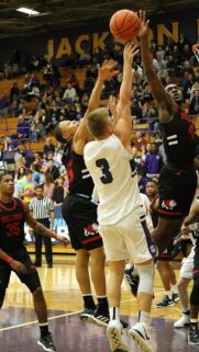 Intense Basketball Action Shot with Players Jumping for a Dunk Wallpaper
