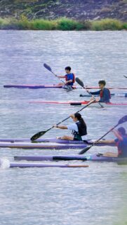 Thrilling Kayaking Race on Serene Waters Mobile Phone Wallpaper