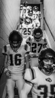 Focused Football Team Walking Down Tunnel Black and White Wallpaper
