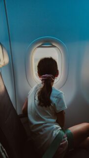 Young Girl Looking Out Plane Window Aesthetic Mobile Wallpaper