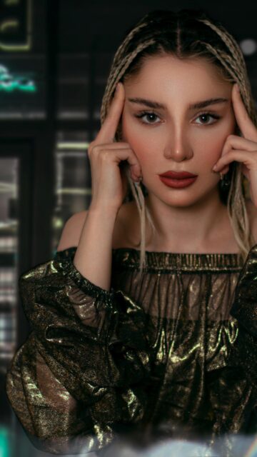 Stunning Woman Portrait with Braided Hair and Golden Blouse Mobile Wallpaper