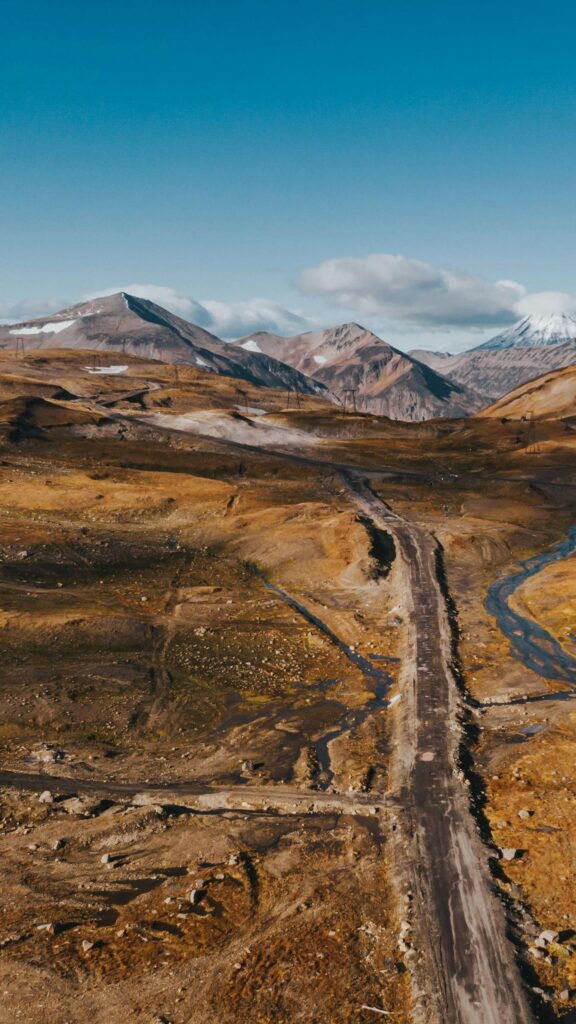 Majestic Mountain Pass and Rugged Wilderness Phone Wallpaper